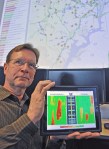 John C. Allen, chair of the Vehicle Probe Project Suite User Group, displays a Congestion Scan, one of the many data visualization tools developed by the University of Maryland's CATT Lab, which are used to facilitate improved transportation planning and operations. The Suite Dashboard is pictured in the background.