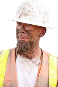 Close-up of an explosives expert just after heavy drilling in preparation for rock blasting.