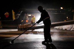 Unknown worker sweeps up State Route 4 after a quick four lane closure during the night for construction.