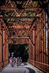 Cyclists ride across an old bridge near Graton, California.
