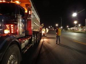 Progress looks different at night, as the asphalt train of trucks and pavers line up beside contractors and Kentucky Department of Highways inspectors to give the daytime commuters a safer and smoother ride.