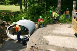 State workers install an upgraded culvert on State Route 772 in Pike County, Ohio. The old culvert was too small to accommodate the water flow, resulting in roadway flooding during heavy rains. The new culvert also prepares the road for planned resurfacing.