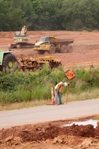 A tired worker directs traffic at an Oklahoma Department of Transportation work zone on SH-9A near Maud.
