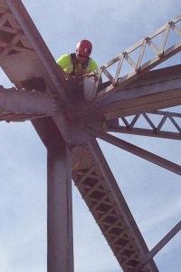 Oklahoma Department of Transportation bridge inspector Wes Kellogg scales the US-169 truss bridge over Bird Creek in Tulsa to perform a detailed inspection.
