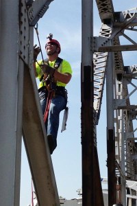 Oklahoma Department of Transportation bridge inspector Wes Kellogg climbs a bridge beam to perform a up-close inspection of the US-169 truss bridge over Bird Creek in Tulsa.