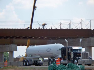 Durant Oklahoma is getting a new bypass on US 70. Workers weld pieces into the bridge supports. The road below remained open throughout construction.