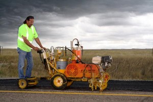 Donnie Boyd, Highway Maintenance Worker from Mission, repaints the center stripe on Highway 83 in Todd County after crews completed an asphalt patching project. Storm clouds threatened, but didn't stop these dedicated workers from getting the job done!