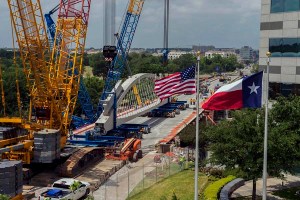 The World’s first pre-cast networked arch bridge is being built in Fort Worth. The arches are constructed off-site and transported to the final site. Here the contractor prepares to place the first arch. The new arch sits on the old bridge that it replaces.