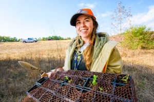 Kayti Ewing holds a flat of milkweed she is about to plant in right-of-way off I-430 in Little Rock, Arkansas. The plants are meant to help the habitat of Monarch butterflies as they migrate through Arkansas.
