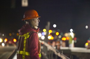 An Idaho Transportation Department worker oversees placement of girders for the Meridian Interchange in Meridian, Idaho. The overnight job began at 10 p.m.